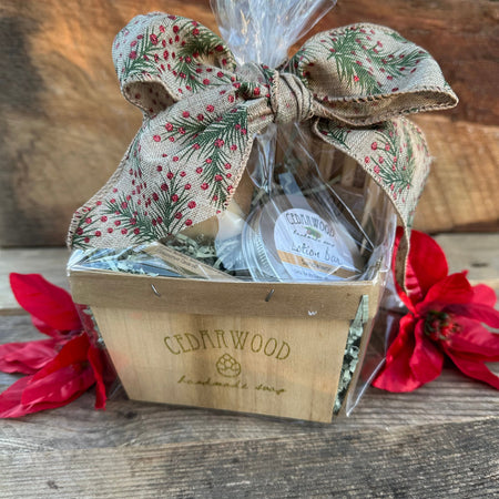 A custom gift basket containing Cedarwood soap and dried flowers, adorned with a floral fabric bow on top.