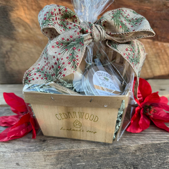 A custom gift basket containing Cedarwood soap and dried flowers, adorned with a floral fabric bow on top.
