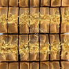 Close-up of orange marigold soap bars with 'Cedarwood' branding.