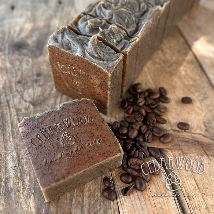 Three bars of Java soap with coffee beans on a wooden surface