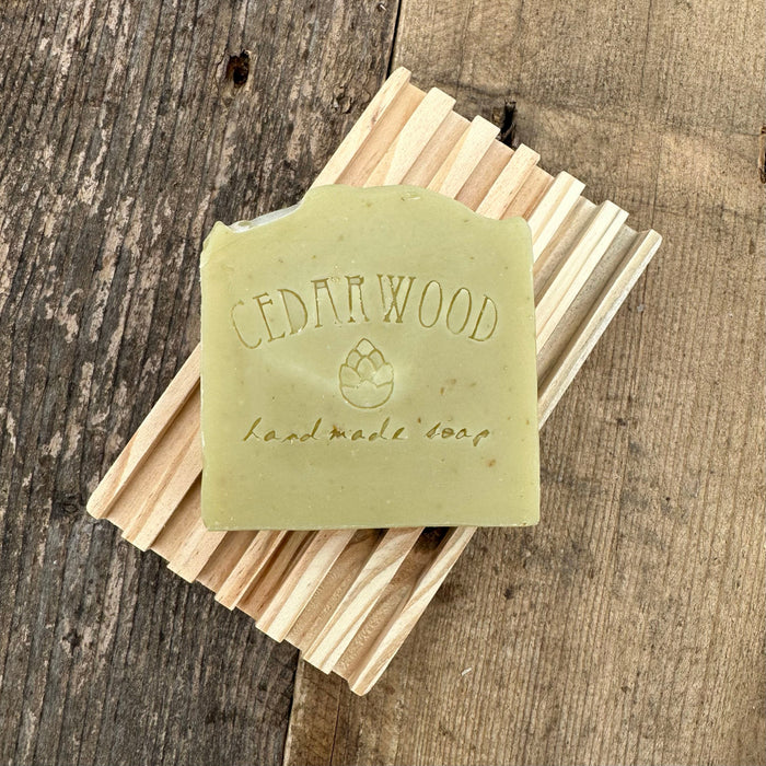 Cedarwood Oatmeal handmade soap bar on wood soap dish 