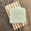 French green clay handmade soap bar on wood soap dish