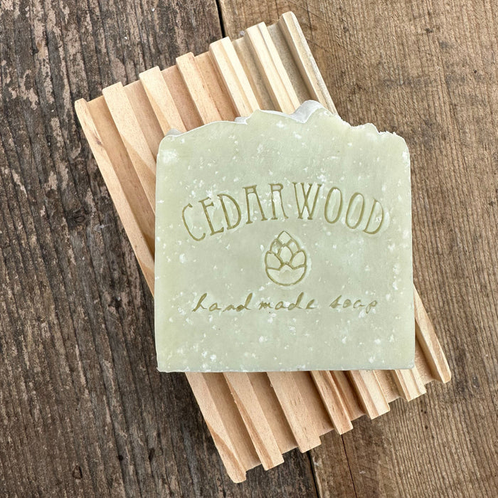 French green clay handmade soap bar on wood soap dish