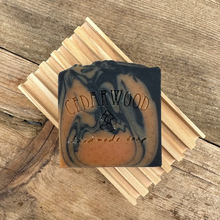 Orange and black Halloween handmade bar soap on wood soap dish