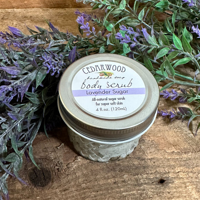 Glass jar of Lavender Sugar body scrub with lavender branches in the background 