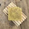 Lemon poppy seed handmade soap bar on wood soap dish