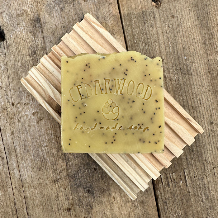 Lemon poppy seed handmade soap bar on wood soap dish