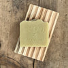 Shaving handmade soap bar on wood soap dish