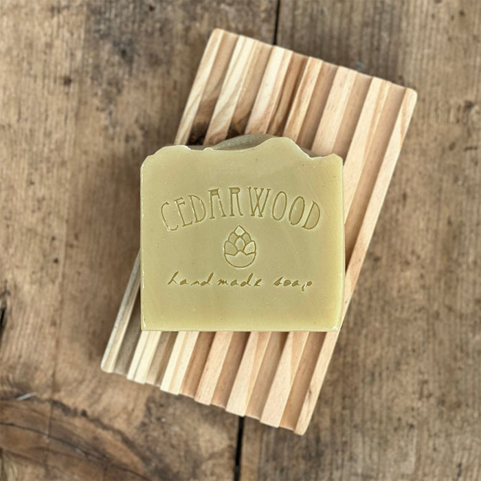 Shaving handmade soap bar on wood soap dish