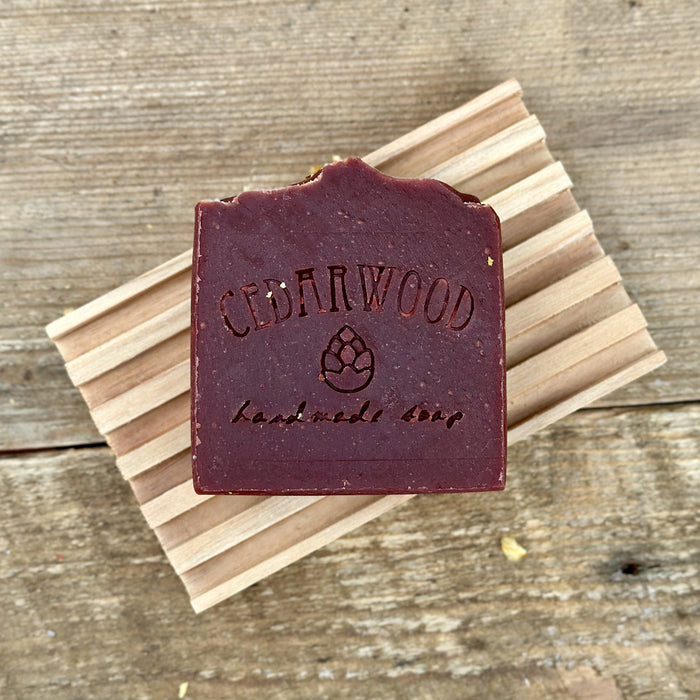 Handmade soap bar made with wine on wood soap dish