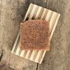 Handmade working hands pumice hand soap on wood soap dish